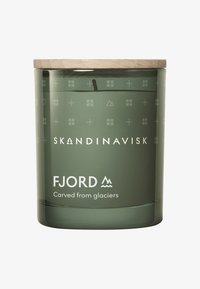 Green glass candle container with a wooden lid, engraved decorative patterns, and "Fjord" label positioned prominently.