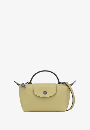 Small pastel yellow leather handbag with top handle, flap closure, and detachable shoulder strap against a white background.