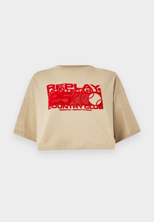 Beige cropped t-shirt, short sleeves, featuring red graphic text and a tennis ball print. Made from soft cotton fabric.