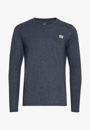 Long-sleeve navy blue shirt made of textured fabric. Features a crew neckline and small logo patch on the left chest.