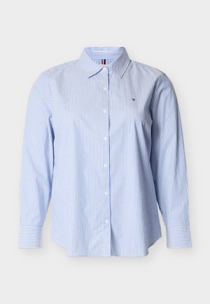 Light blue and white striped button-up shirt with a collar and long sleeves. Features a small logo on the chest and a relaxed fit.