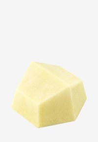 Geometric-shaped soap in pale yellow, smooth texture, with angular facets and a matte finish, presenting a minimalist design.