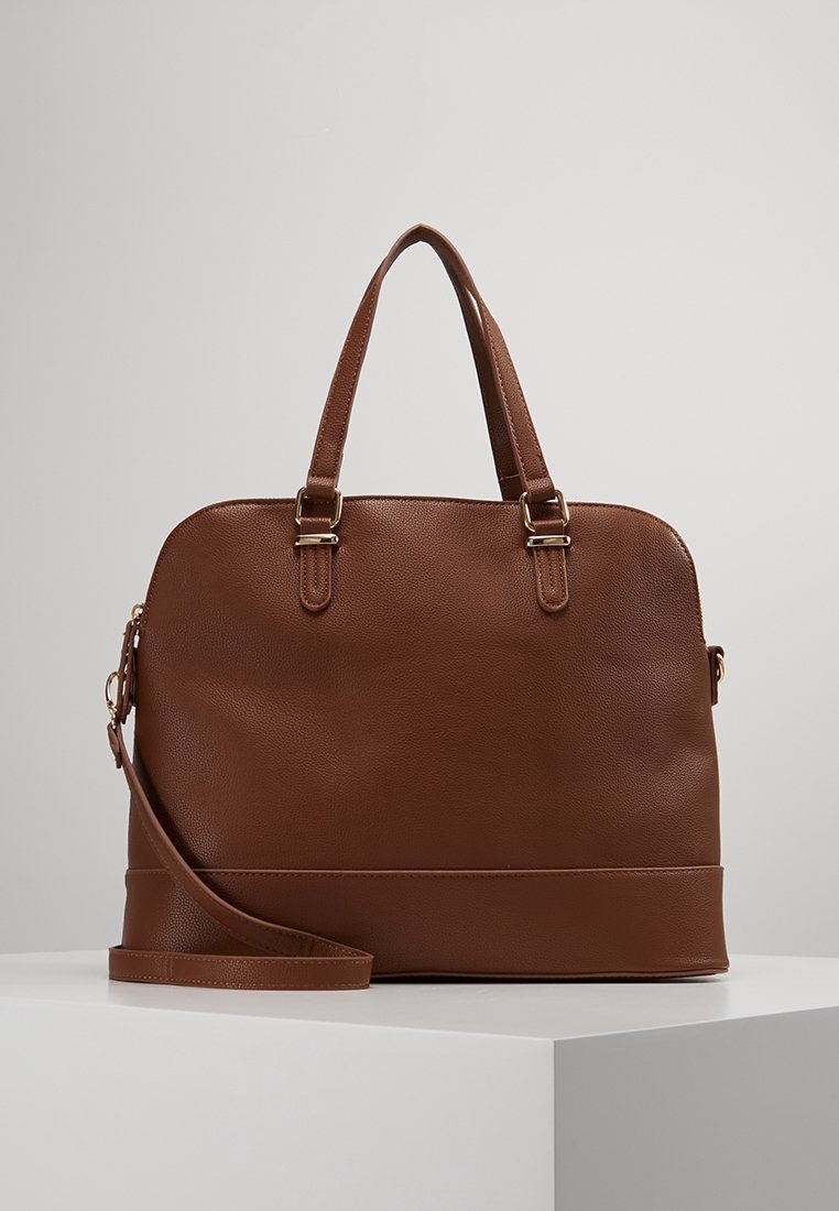 Brown leather handbag with dual top handles, detachable shoulder strap, and smooth textured body. Features gold-tone hardware and a structured shape.
