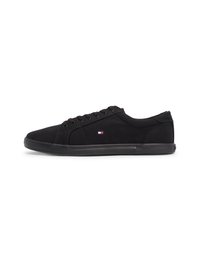 Black canvas sneakers with a low-top design, featuring six eyelets, black laces, subtle white and blue logo detail, and a textured rubber sole.