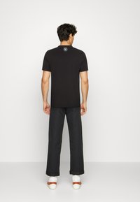 Puma GRAPHIC - Triko s potiskem - black