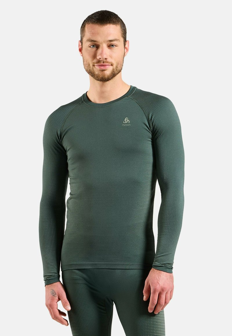 Green long-sleeve thermal top with a textured pattern, crew neckline, and fitted design, made from moisture-wicking material.