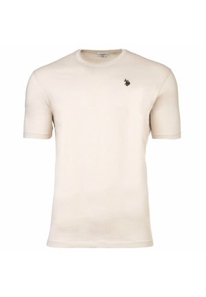 Beige T-Shirt mit kurzen Ärmeln und Rundhalsausschnitt, das ein kleines dunkles Polo-Spieler-Logo auf der linken Brust zeigt.