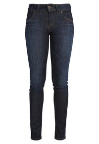 Jeans ajustados en denim azul oscuro, con cierre de botón y cremallera, bolsillos frontales y una textura suave. Sin patrones distintivos.