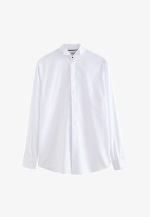 Camicia bianca a maniche lunghe con colletto alla mandarino, vestibilità su misura, texture liscia e chiusura frontale con bottoni. Presenta placca con bottoni e polsini.