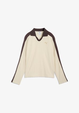 Kreemjas triiksärk pikkade varrukatega, tumepruun krae ja õlastriipudega, soonilise tekstuuriga ning väike kuldne Puma logo rinnal.