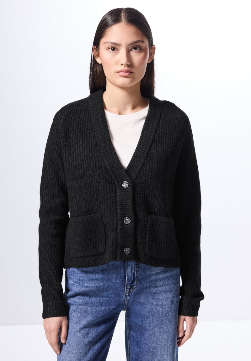 Svart stickad cardigan med V-ringning, femknapsknäppning och två framfickor. Ribbstruktur och lång ärm.