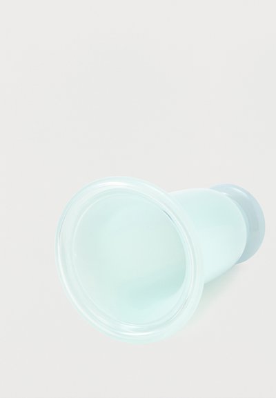 Διαφανής αντλία στήθους από σιλικόνη σε απλό λευκό φόντο, παρουσιάζοντας ευρύ ανοιχτό στόμιο και καμπυλωτό σώμα.