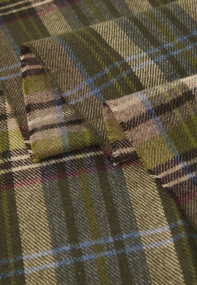 Tessuto di lana in un design a quadri con linee verdi, marroni e blu, caratterizzato da una trama morbida. I bordi sono sfrangiati, aggiungendo dettagli al motivo.