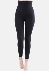 Leggings neri a vita alta realizzati in un tessuto elastico e liscio. Presentano un design aderente senza cuciture visibili alla caviglia.