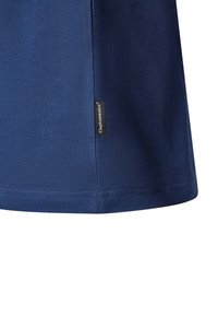 Navy blue cotton t-shirt featuring a side logo tag, a smooth texture, and a rounded hem with stitched edges.