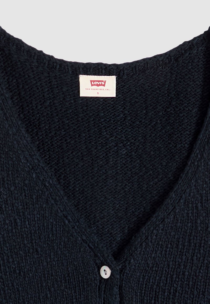 Black knitted Levi's cardigan with V-neck collar, single white button, and size S label sewn inside the neckline.