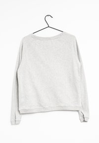Grijze sweatshirt met een ronde hals en raglanmouwen, voorzien van ribgebreide manchetten en onderrand, gemaakt van zachte textuurstof.
