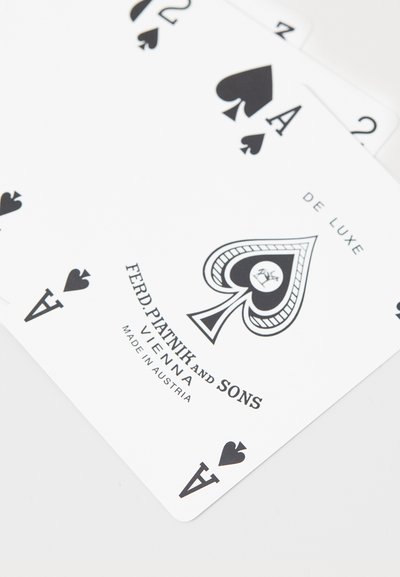 Playing cards with a white background featuring black spade symbols. Text includes "DE LUXE" and "FERD. PIATNIK AND SONS, VIENNA, MADE IN AUSTRIA."