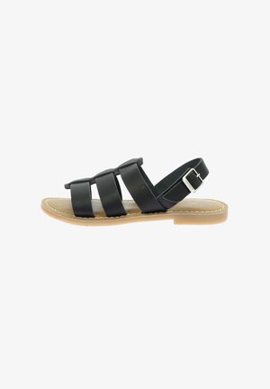 Sandale en cuir noir avec trois larges bandas, boucle de cheville ajustable, semelle plate et liseré brun clair. Design décontracté adapté aux temps chauds.