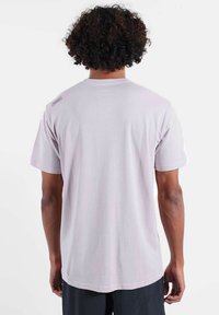 T-shirt rose clair à manches courtes en coton. Caractérisé par un design simple avec un ourlet droit et une étiquette sur l'épaule gauche.