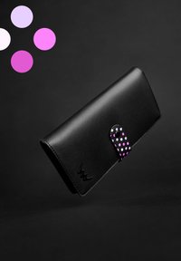 Black leather wallet with a purple polka dot clasp. Features a smooth texture and embossed design on the front.