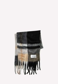 Écharpe à carreaux en laine douce comportant des couleurs noir, gris, beige et blanc ; avec des bords à franges et une étiquette en tissu.