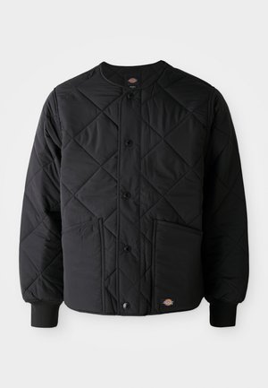 Black quilted jacket with snap buttons, two front pockets, ribbed cuffs, and a visible small logo patch at the front hem.