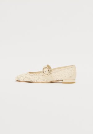 Beige lace ballet flats with a pointed toe, lace overlay, and a side strap featuring a round gold buckle. Flat heel and smooth inner lining.