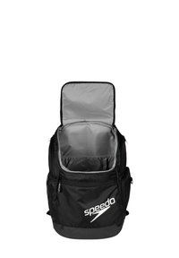Zaino nero con interno grigio, dotato di una parte superiore con zip, ampio scomparto principale e logo Speedo sul davanti.