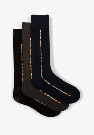 Three pairs of socks in black, dark gray, and navy, featuring colorful striped patterns along the sides. Made from a soft, stretchy material.
