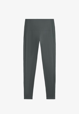 Tajice u tamno sivoj boji, izrađene od glatkog, rastezljivog materijala. Imaju visoki pojas i teksturirane bočne panele kao dodatni detalj.