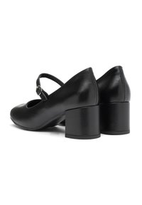 Chaussures à talons noirs avec un bout rond et une bride sur le dessus du pied. Fabriquées en cuir lisse avec un talon carré épais.