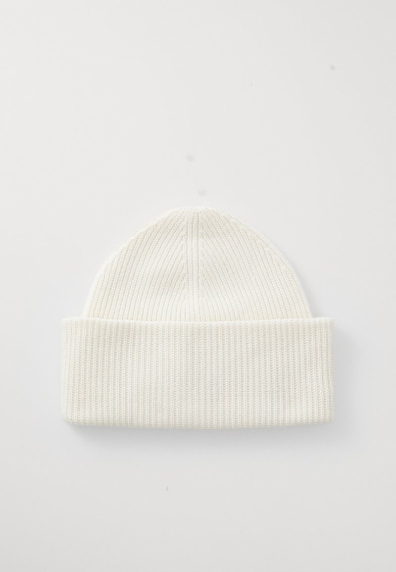 White ribbed knit beanie with a folded cuff, featuring a seamless design and soft texture, suitable for casual wear in colder weather.