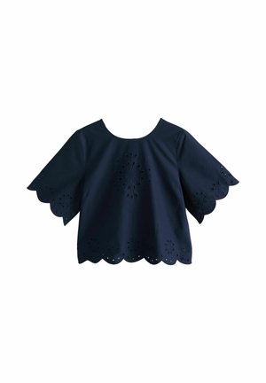 Navy blue short-sleeve blouse with scalloped edges and floral eyelet embroidery on sleeves, front, and hemline.