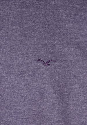Purple sweatshirt with a soft texture, featuring a small embroidered logo in a slightly darker purple. Simple, unembellished design.