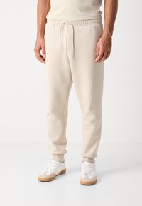 BOSS HADIKO - Spodnji deli trenirk - light beige