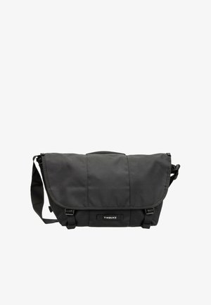 Borsa messenger nera Timbuk2 con tracolla regolabile, chiusura a patta e due fibbie frontali.