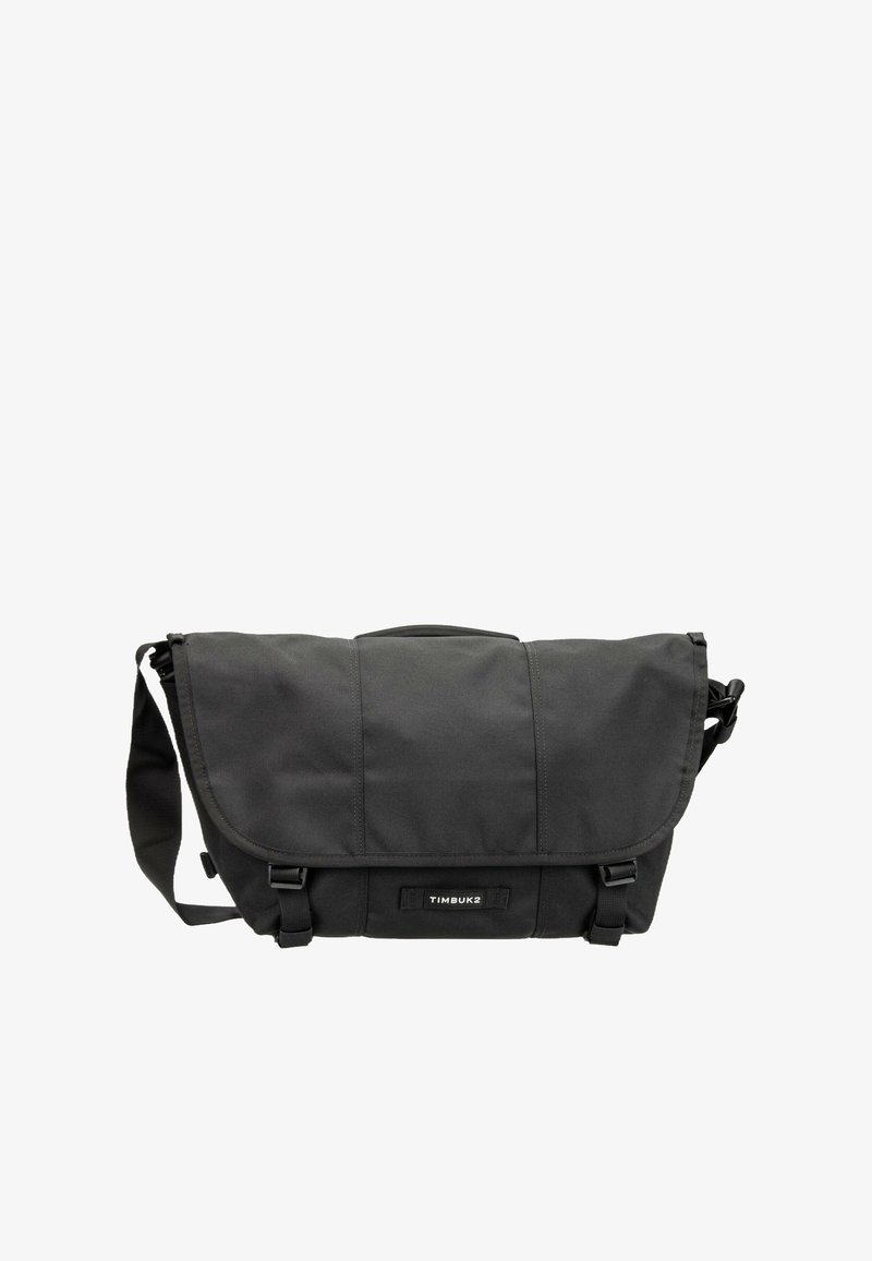 Sac messager noir Timbuk2 avec bandoulière réglable, fermeture à rabat et deux boucles à l'avant.