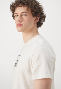 ASICS COURT CORE GRAPHIC TEE - T-shirts print - cream
