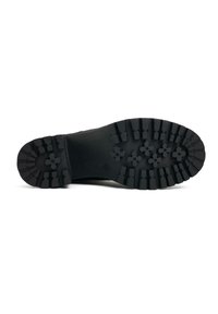 Black rubber sole with deep treads and floral-patterned grip. Sturdy and textured finish, designed for traction and durability.