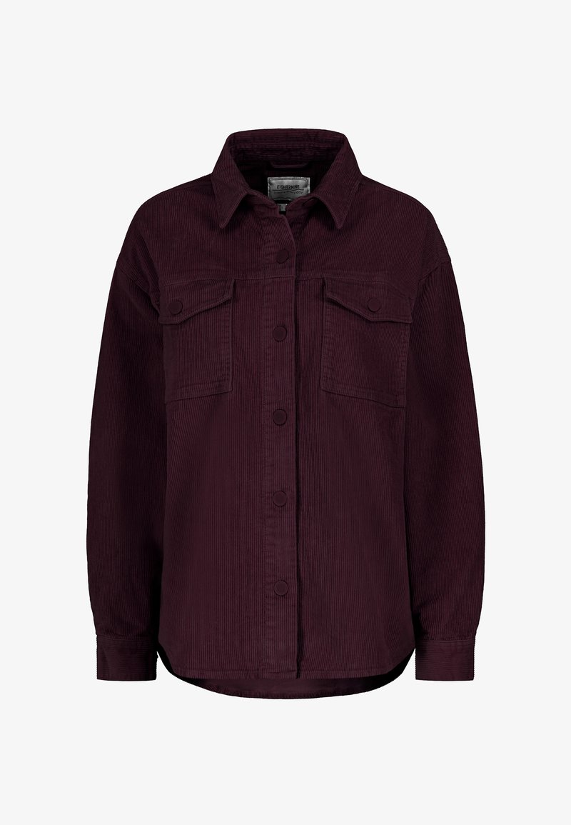 Burgundy corduroy shirt with a button-up front, two chest pockets, long sleeves, and a slightly curved hem. Textured fabric with visible ridges.