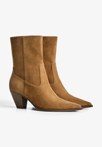Brown suede ankle boots with a pointed toe, elastic side panels, and a stacked heel. The texture is soft, with a smooth finish.