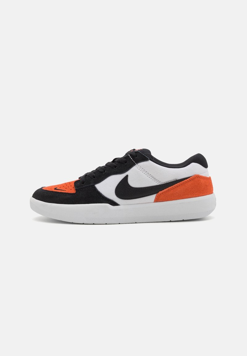 Nike sneakers featuring a black, white, and orange color scheme. Made of suede and canvas with a perforated toe and rubber sole.