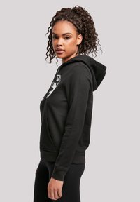 Black cotton hoodie with front pocket, drawstring hood, and printed design on the chest. Features ribbed cuffs and hem.