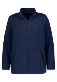 Giacca in felpa blu navy con colletto alto e zip frontale. Presenta una texture liscia e senza motivi visibili, con un discreto dettaglio del logo.