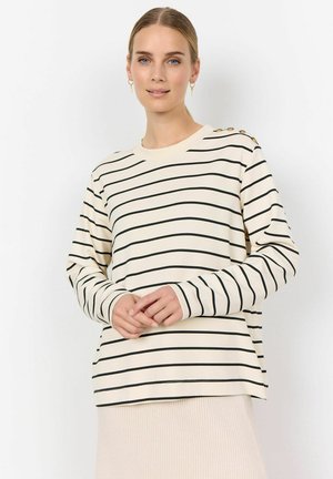 Haut à manches longues beiges rayé avec des rayures noires, encolure ras du cou, et accents de boutons métalliques sur l'épaule. Tissu doux et lisse.