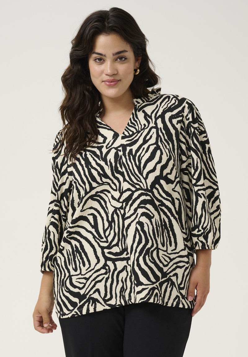 Schwarz-weiße Bluse mit Zebra-Print, V-Ausschnitt und drei Viertelärmeln, aus strukturiertem Stoff mit lockerer Passform.