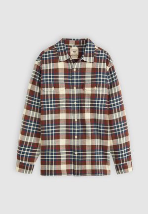 Chemise à carreaux rouge, bleu et crème avec des manches longues, deux poches poitrine, fermeture à boutons et une coupe décontractée. Texture en coton.