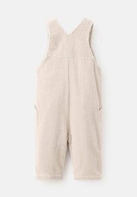 Beige ribbed corduroy sleeveless overalls for a child, featuring wide shoulder straps and side pockets.