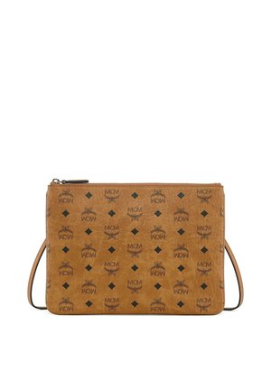 Rectangular tan leather crossbody bag with repeated black MCM logos, diamond shapes, and winged designs, featuring a zipper closure and thin strap.
